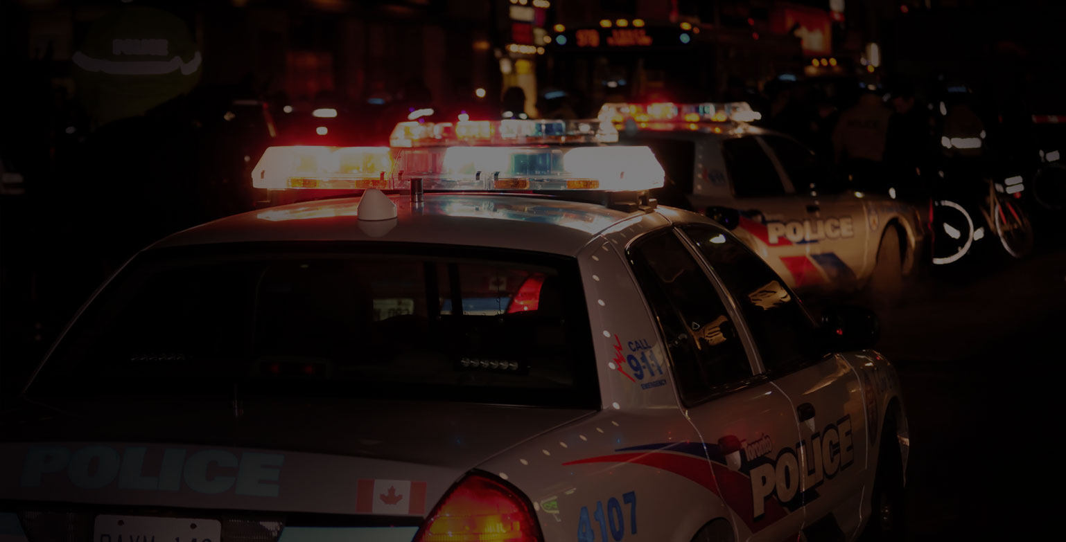 Night photo of a Ontario Police Car with its lights on